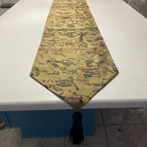 Table runner: 88” gold w/ black abstract markings & 6” black tassel on each end